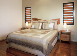Shimmering bamboo floors blend with the elegant bedroom decor